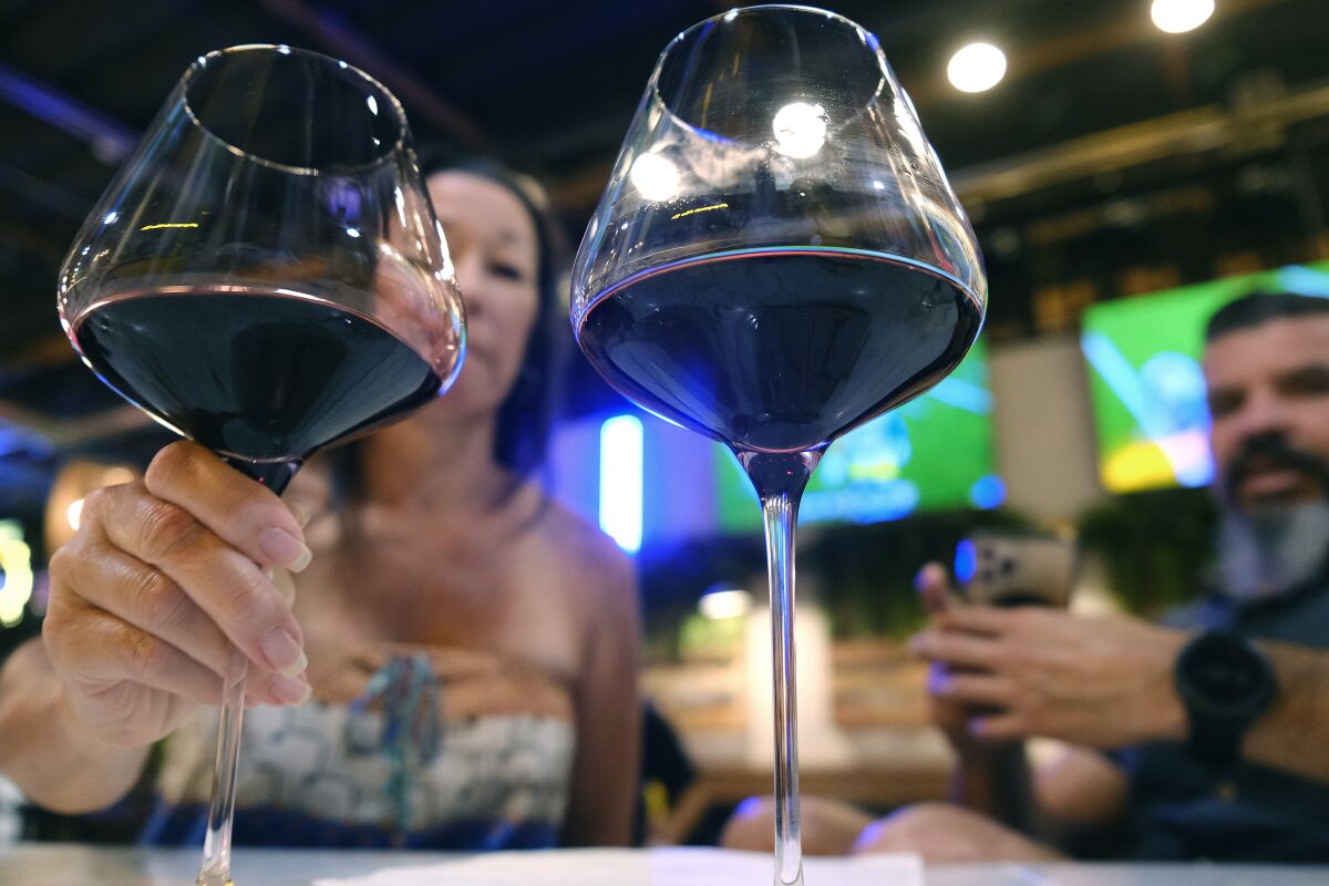 Tayna Davis and Jesse Martinez drink wine at the CoLab Public House in Vista.