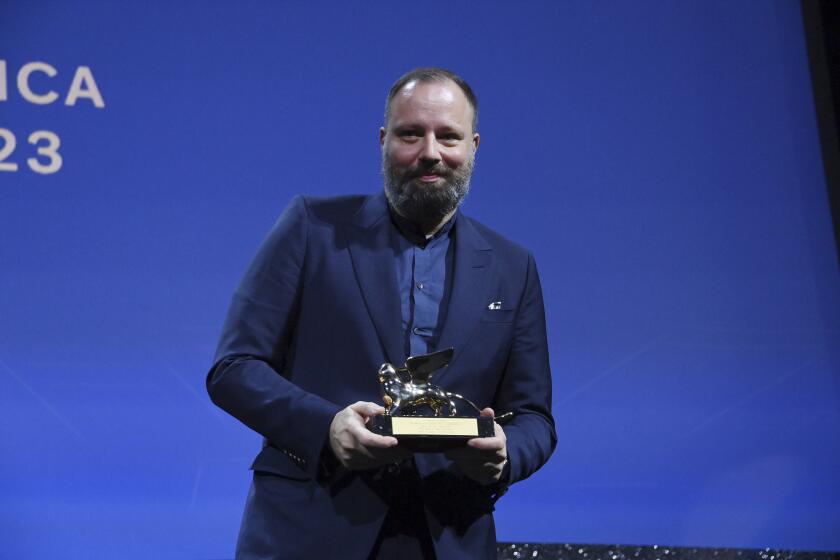 Greek director Yorgos Lanthimos poses with the 'Golden Lion' award for the best film 'Poor Things' during the closing ceremony for the 80th edition of the Venice Film Festival in Venice, Italy, Saturday, Sept. 9, 2023. (Gian Mattia D'Alberto/LaPresse via AP)