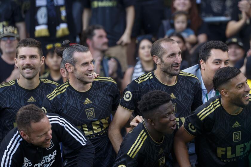 Los Angeles FC forward Gareth Bale (11) and defender Giorgio Chiellini (14) join their team celebrate.