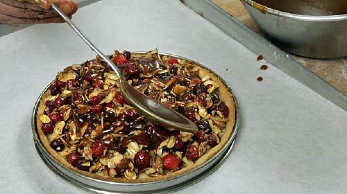 A cranberry, caramel and almond tart, just right for serving at Thanksgiving dinner.