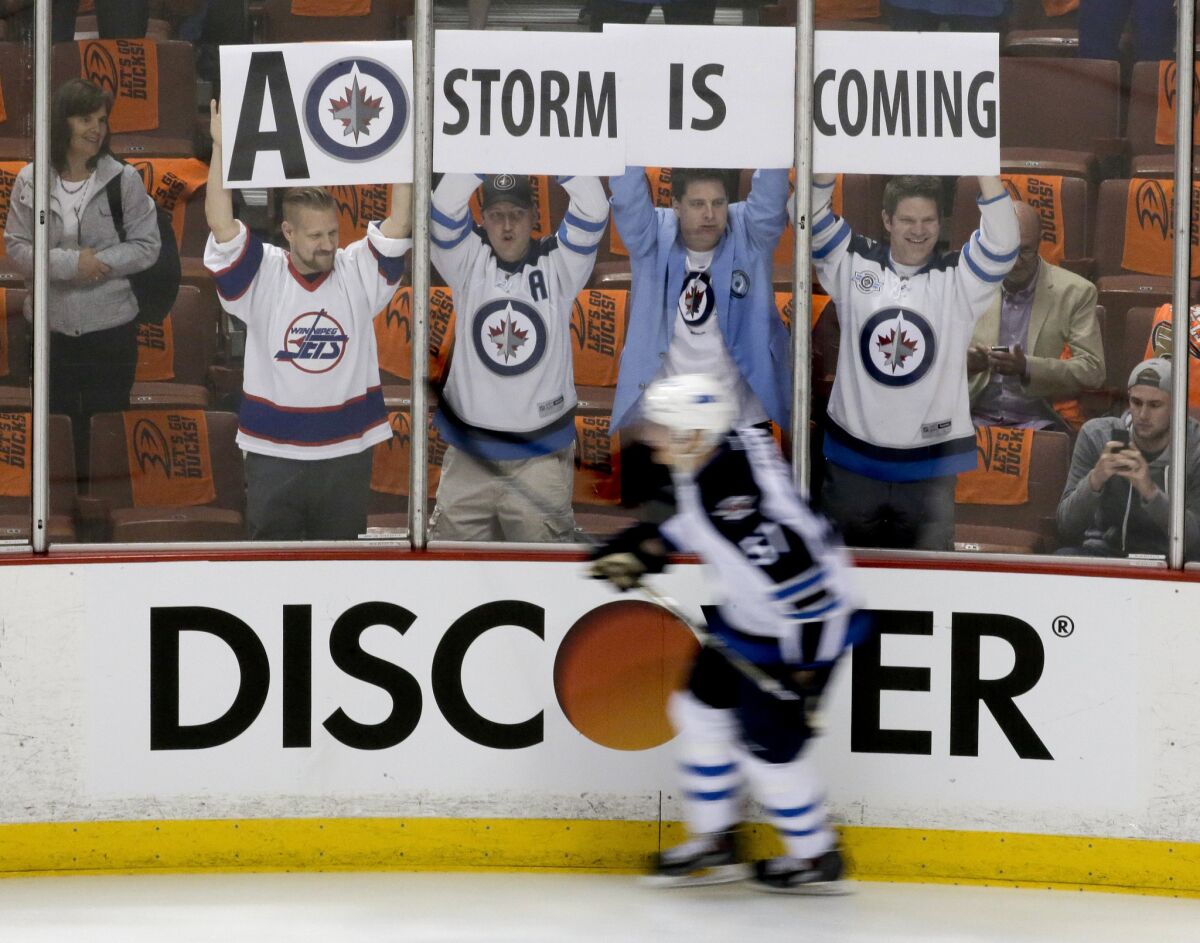 Winnipeg fans cheer April 16 as Jets center Andrew Copp skates past before Game 1 of a playoff series against the Ducks at Honda Center.