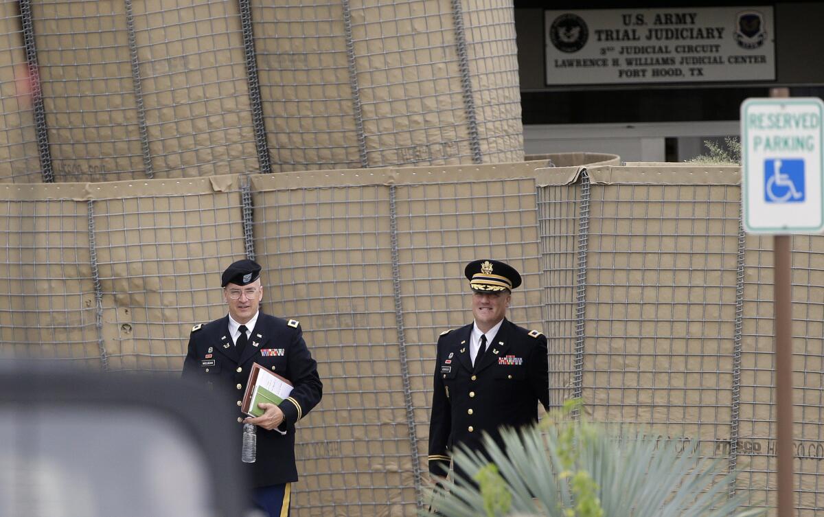 Prosecutors Col. Mike Mulligan, left, and Col. Steve Henricks leave the Lawrence William Judicial Center at Ft. Hood, Texas, after the second day of the sentencing phase in the trial for Maj. Nidal Hasan.