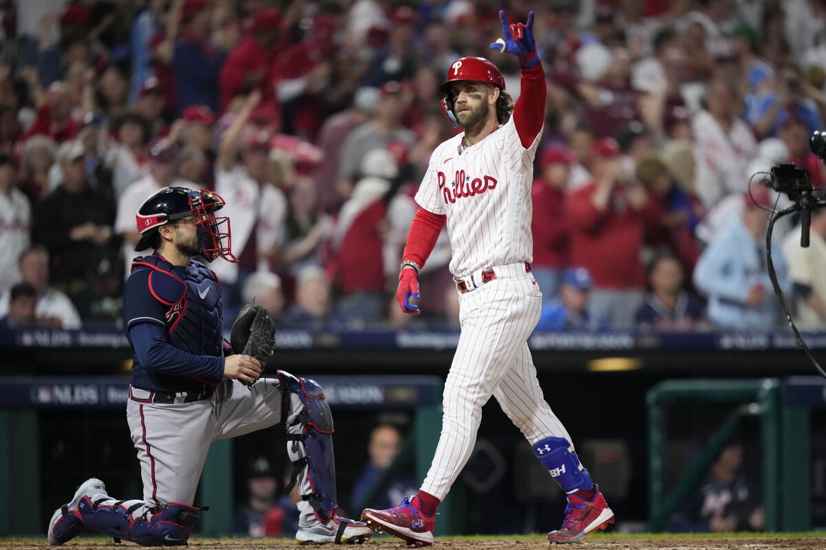 Philadelphia Phillies' Bryce Harper reacts after hitting a home run.