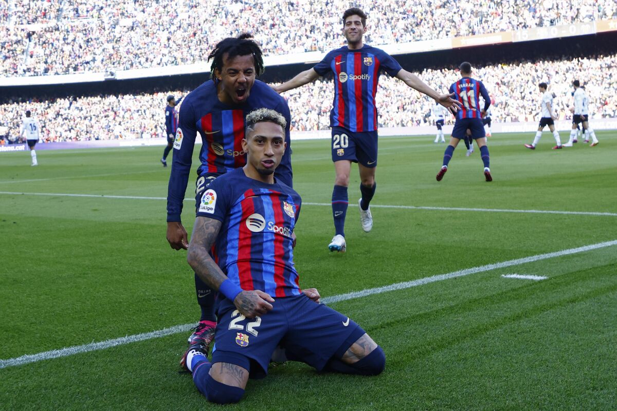 Barcelona's Raphinha celebrates scoring his side's opening goal during Spanish La Liga soccer match between Barcelona and Valencia at the Camp Nou stadium in Barcelona, Spain, Sunday, March 5, 2023. (AP Photo/Joan Monfort)