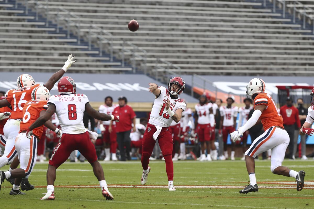 North Carolina State quarterback Devin Leary (13) throws a pass against Virginia during an NCAA college football game, Saturday, Oct. 10, 2020, at Scott Stadium in Charlottesville, Va. (Erin Edgerton/The Daily Progress via AP)