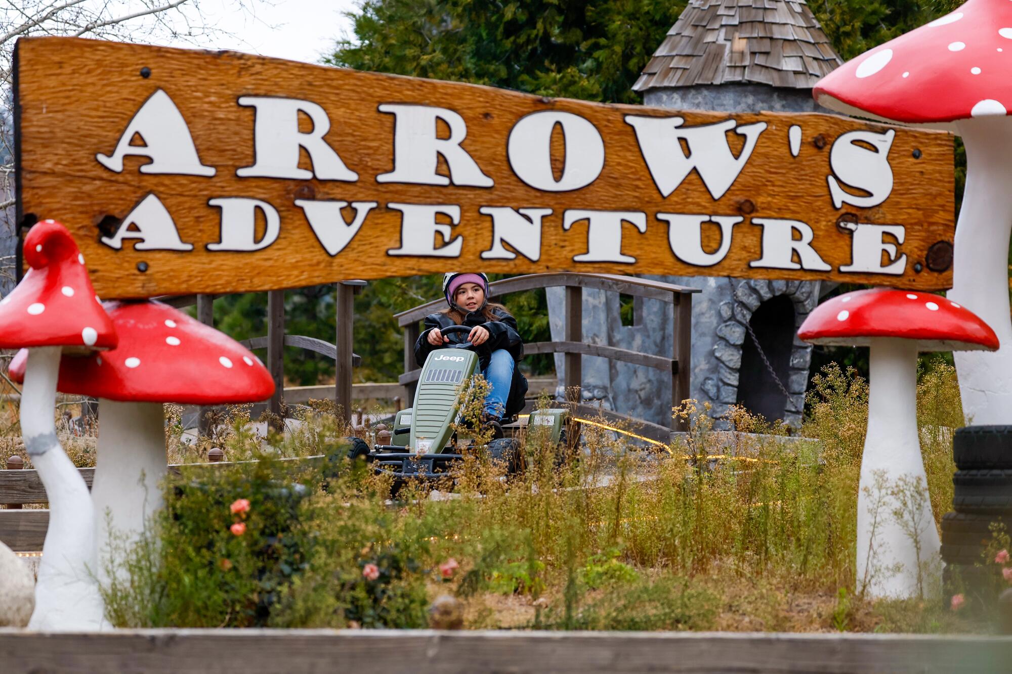 Kaia Aguilar, 8, from Laguna Hills pedals a car on Arrow’s Adventure track.