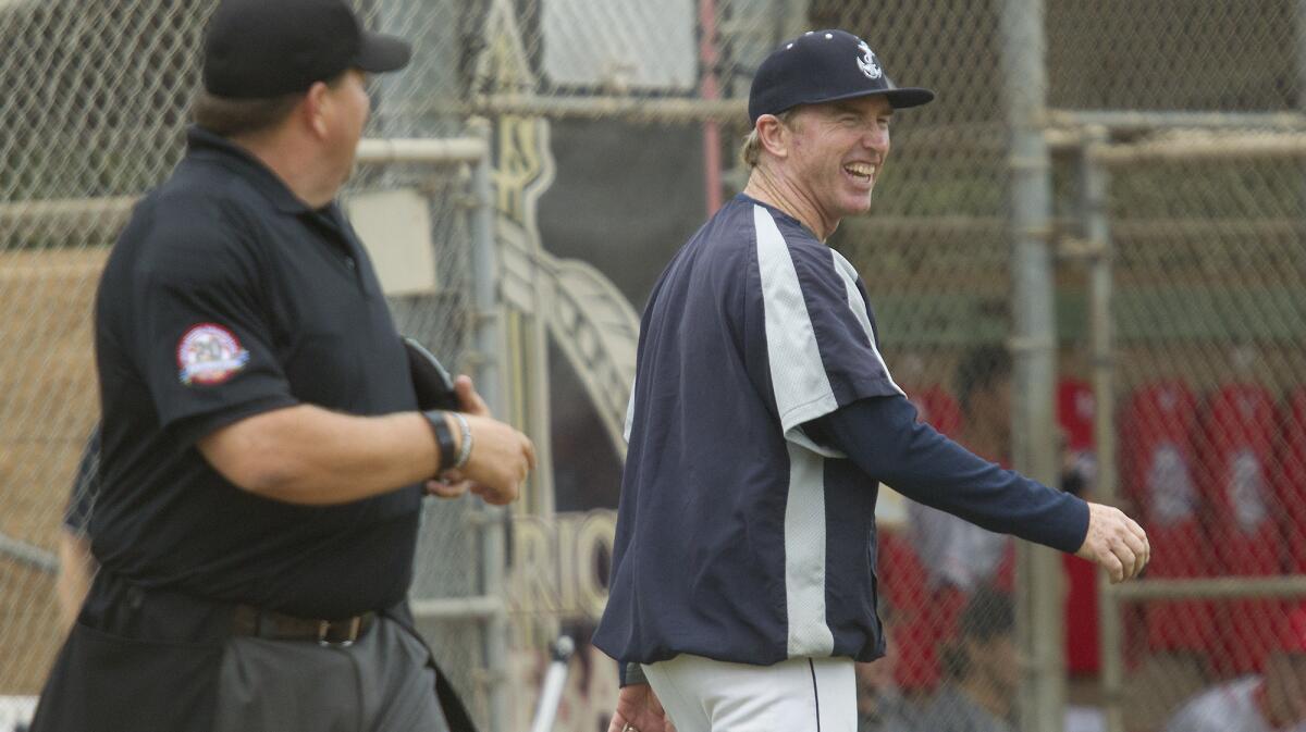 Newport Harbor High coach Evan Chalmers, shown sharing a laugh with the umpire on June 11, 2016, will lead the Sailors in their game against Orange Lutheran on Jan. 16 as part of the Sunset/Trinity Baseball Challenge.