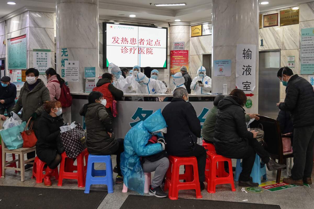 People wait to be seen by medical staff at Wuhan Red Cross Hospital in Wuhan.