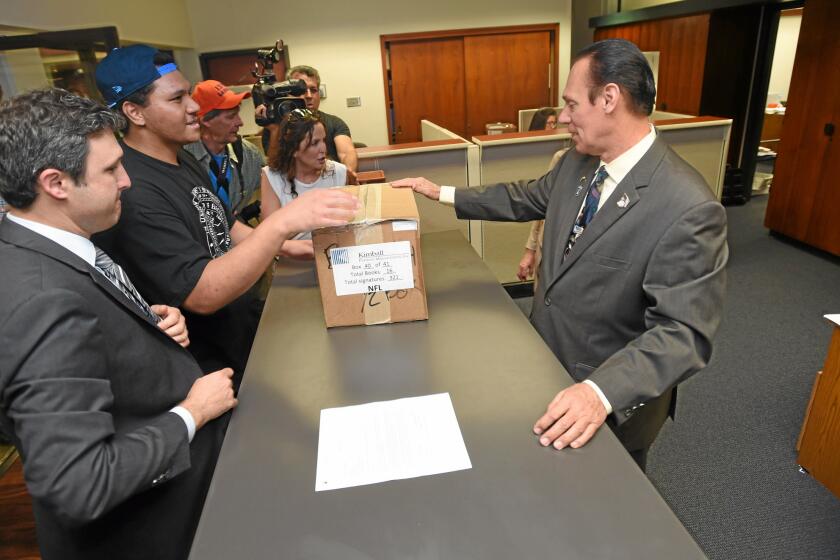 Carson2gether supporters and proponents deliver boxes of signed petitions for the proposed NFL football stadium to Carson Mayor Jim Dear inside Carson City Hall on March 25.