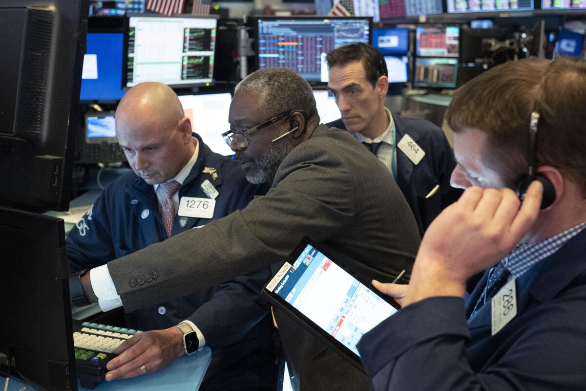 Traders at the New York Stock Exchange work as the market closes Wednesday.
