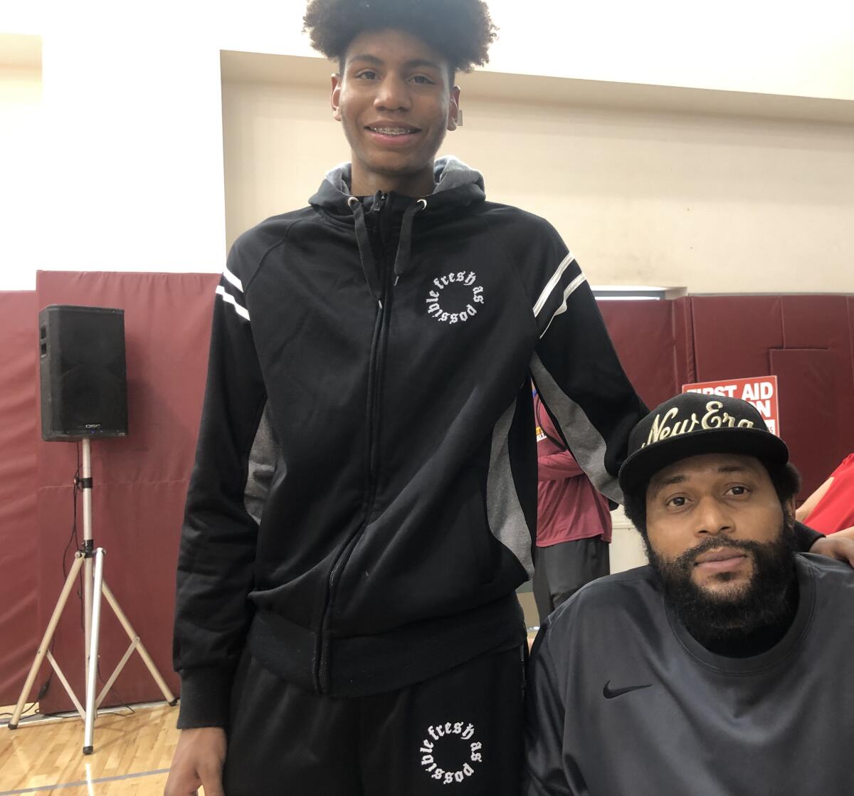 Etiwanda's Tyree Campbell (left) with his father, Zerrick, who was involved in a serious car accident last August that required amputation of his legs.
