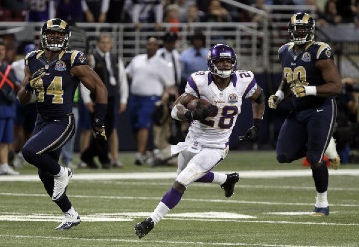 Adrian Peterson runs against the St. Louis Rams on Sunday.