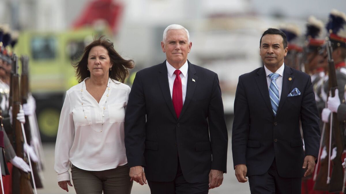 U.S. Vice President Mike Pence and wife Karen are escorted by Guatemalan Vice Foreign Minister Pablo Garcia, right, on arrival at an air base in Guatemala City on June 28, 2018.