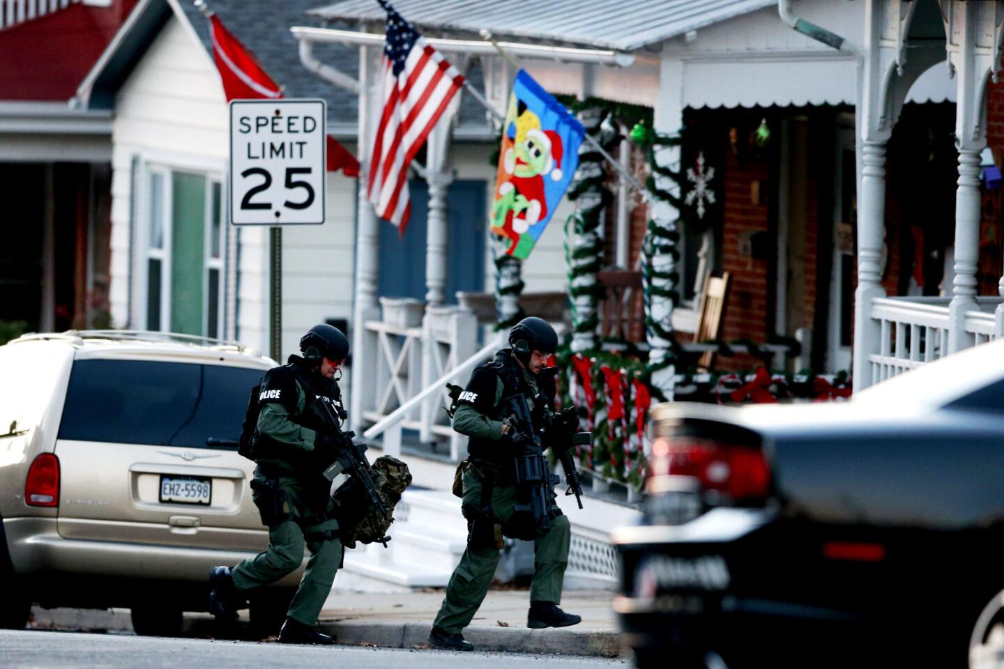 Police on Dec. 15 take positions near a home in Pennsburg, Pa., where authorities were seeking multiple-slaying suspect Bradley William Stone.