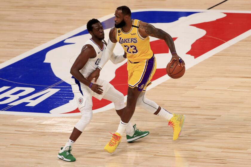 Los Angeles Lakers' LeBron James (23) dribbles the ball against Los Angeles Clippers' Reggie Jackson.