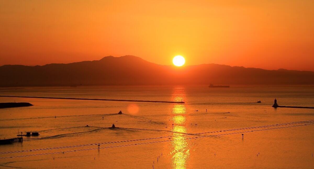 A beautiful view of the sun rising over Los Angeles harbor. In recent days, the sun has gone eerily quiet solar observers say.