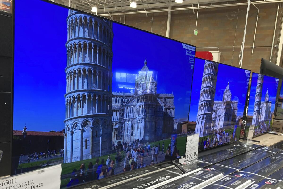 FILE - A 65-inch television is shown at a warehouse, Thursday, June 17, 2021, in Lone Tree, Colo. Buy now, pay later loans allow users to pay for items such as new sneakers, electronics or luxury goods in installments. (AP Photo/David Zalubowski, File)