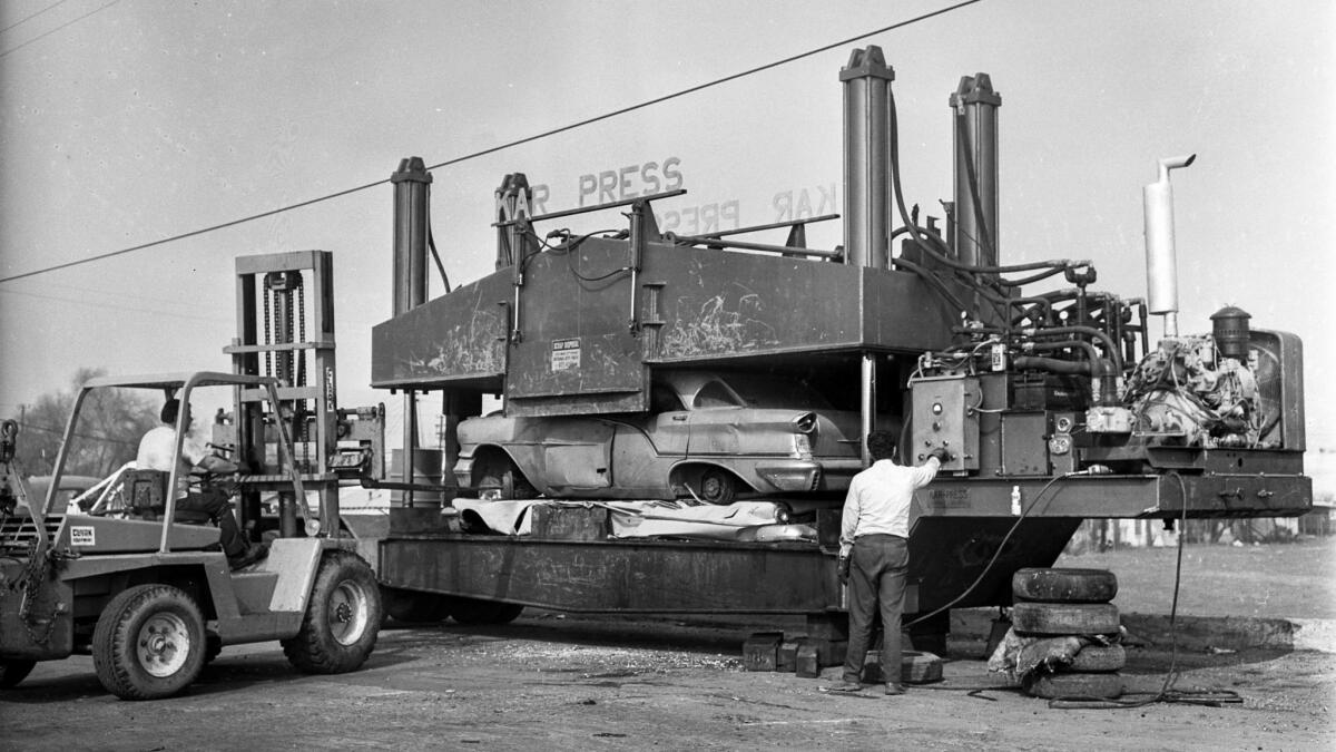 Jan. 25, 1972: Automobile being crushed in the Kar Press at a wrecking-recycling yard in Lynwood.