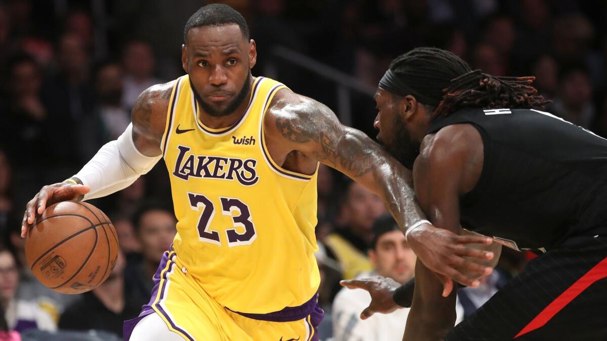 Lakers' LeBron James dribbles past Clippers' Montrezl Harrell on March 4.