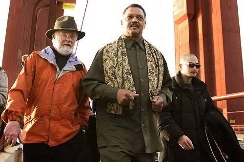 Jesse Jackson, Lyle Grosjean, left, and Hong Chingkuang lead about 30 anti-death penalty protesters across the Golden Gate Bridge early Monday. Grosjean is a retired Episcopal minister, and Chingkuang is a prison program coordinator for the Buddhist Peace Fellowship.