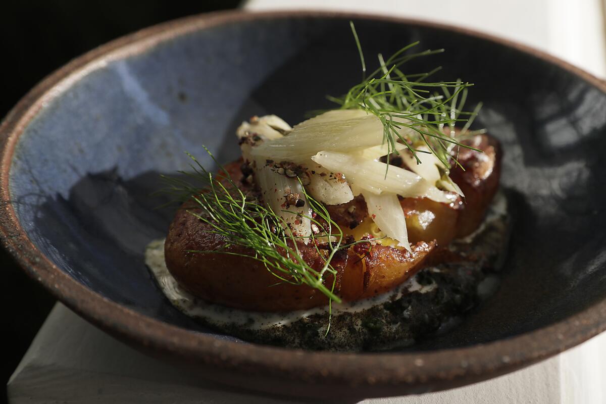 Crispy confit potato with kefir, Swiss chard and lamb fat, on the patio at the Hearth & Hound.