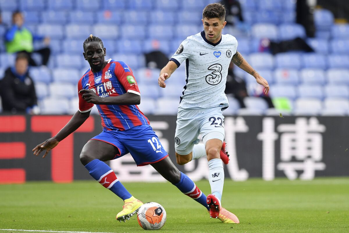 FILE - In this Tuesday, July 7, 2020 file photo, Crystal Palace's Mamadou Sakho, left, and Chelsea's Christian Pulisic in action during the English Premier League soccer match between Crystal Palace and Burnley at Selhurst Park, in London, England. Center-back Mamadou Sakho signed with French club Montpellier on Tuesday July 27, 2021, after playing eight seasons in the Premier League. (Justin Tallis/Pool via AP, File)