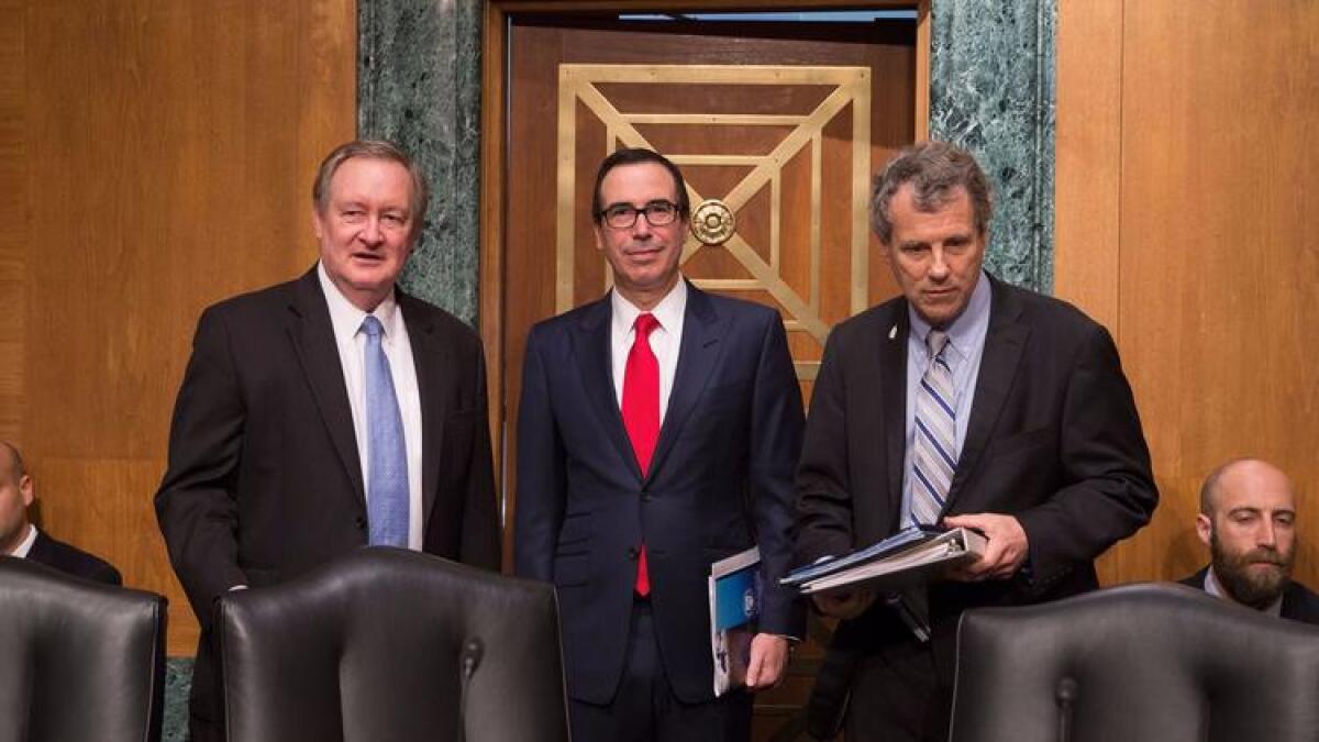 Senate Banking Committee Chairman Mike Crapo (R-Idaho), left, Treasury Secretary Steven T. Mnuchin and Sen. Sherrod Brown (D-Ohio).