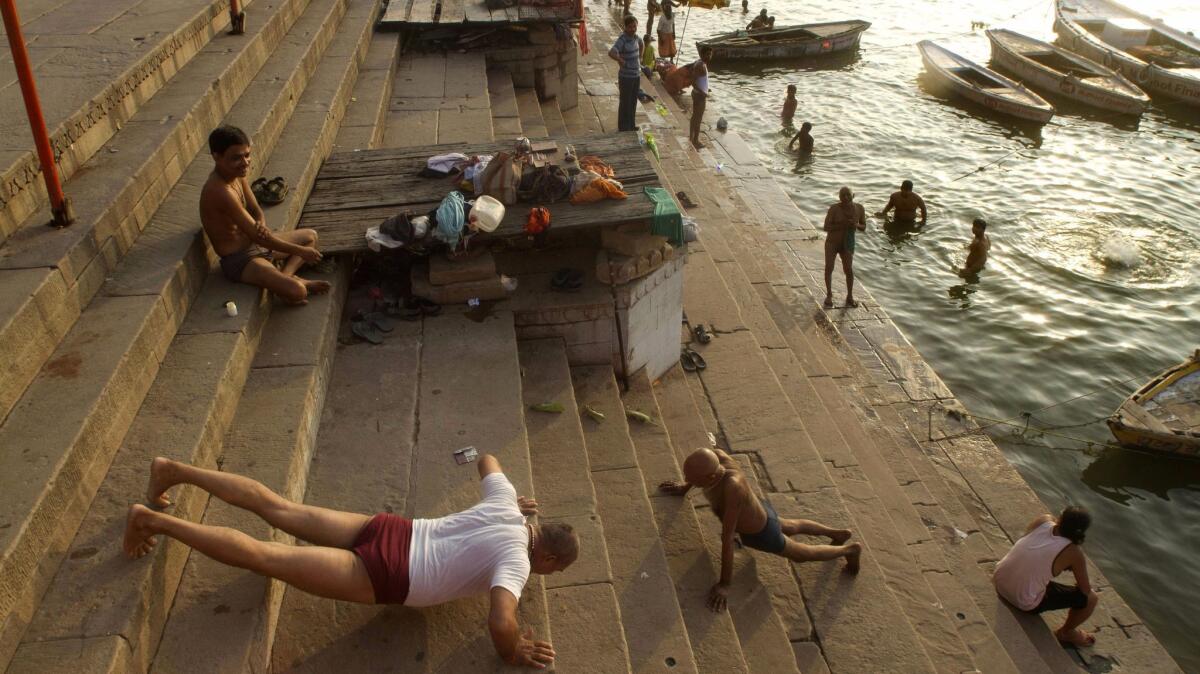 Men perform morning exercises by the Ganges River in Varanasi, one of India’s most sacred sites, in 2012.