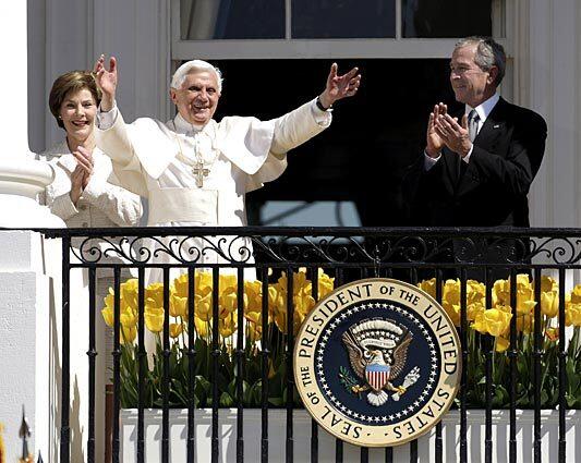President Bush and First Lady Laura Bush flank Pope Benedict XVI as he waves to the crowd from the balcony of the White House today.