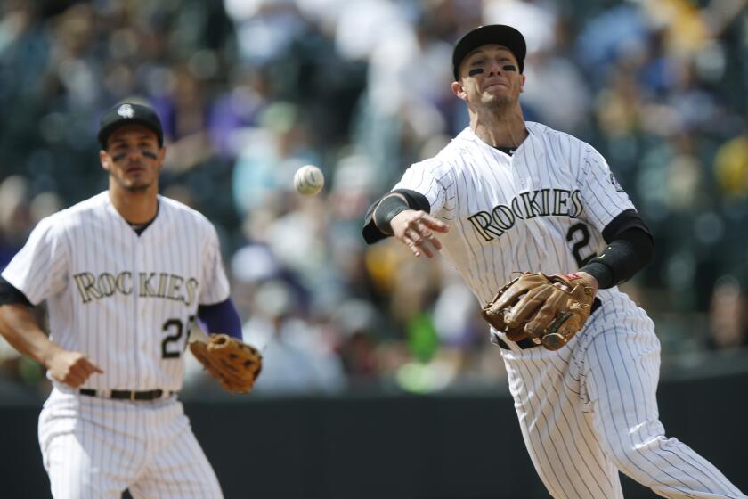 Rockies shortstop Troy Tulowitzki throws to first base, where San Diego outfielder Wil Myers is called out during a game on April 23.