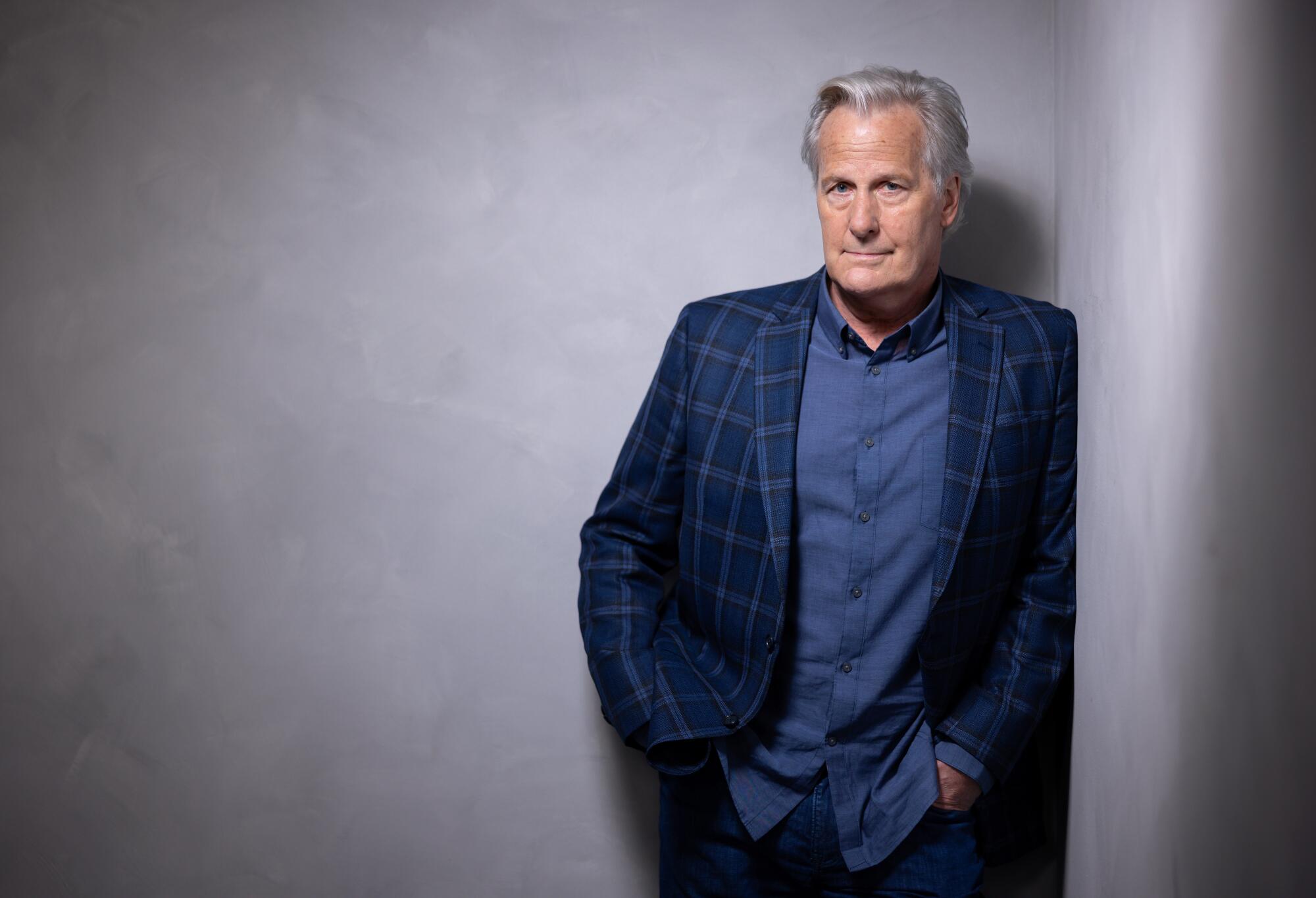 Jeff Daniels stands in a corner for a portrait.