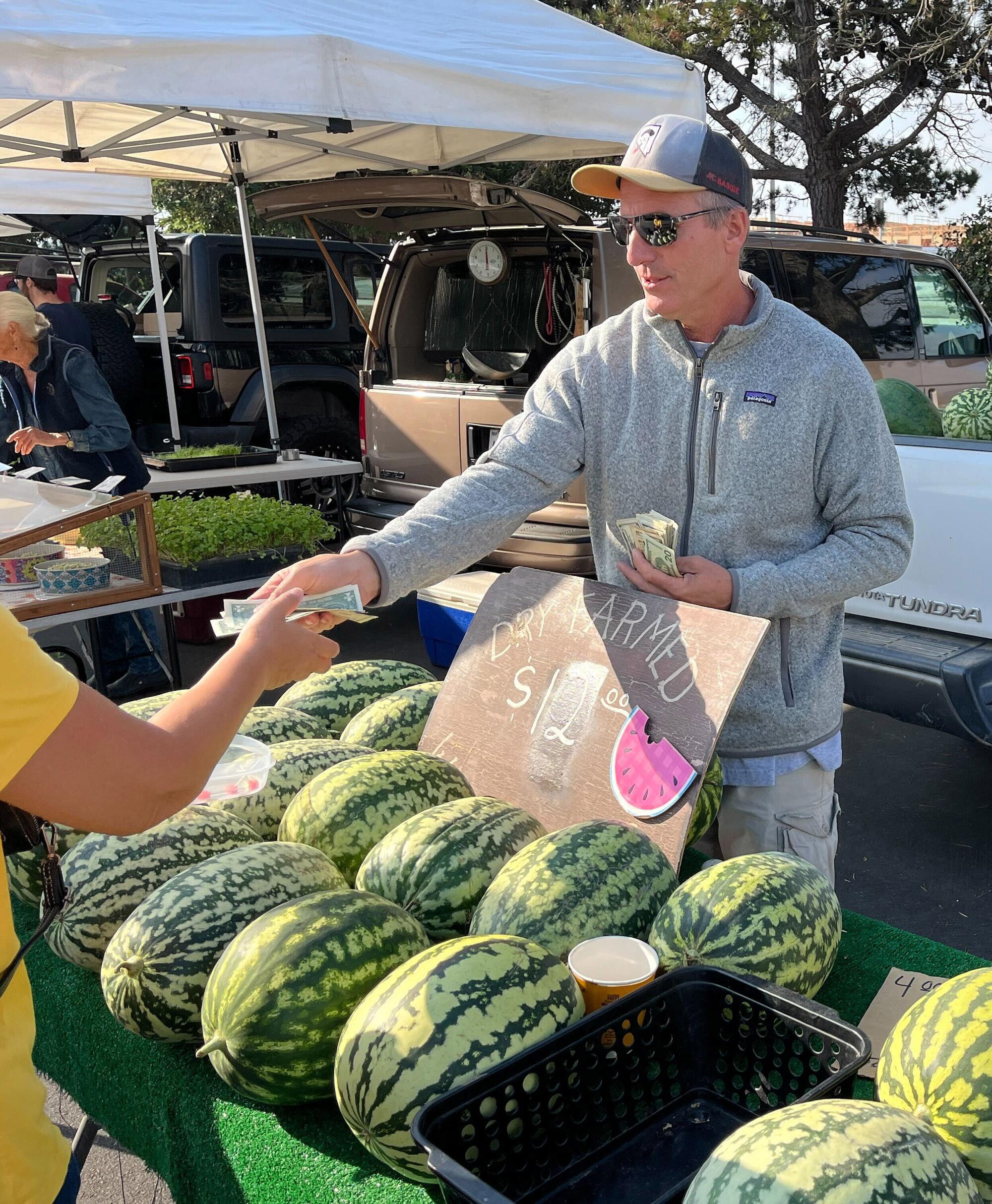 John Lahargou sells watermelons from a truck.