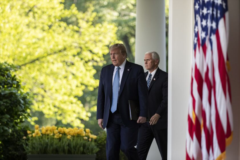 President Donald Trump, followed by Vice President Mike Pence, walks on the Colonnade to speak about the coronavirus in the Rose Garden of the White House, Wednesday, April 15, 2020, in Washington. (AP Photo/Alex Brandon)