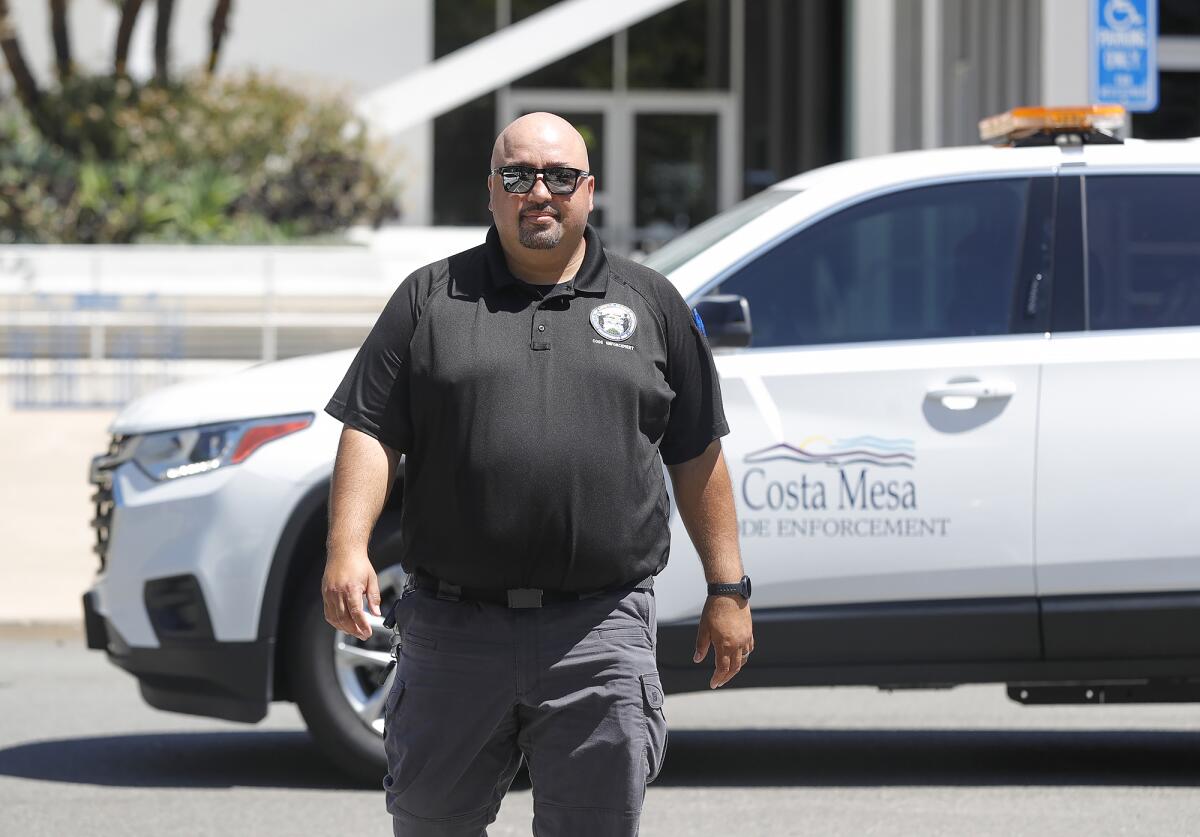Code Enforcement Officer Andy Godinez walks from City Hall to his work vehicle. 