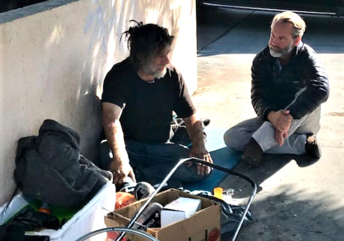 Dr. Jonathan Sherin, director of the Los Angeles County Department of Mental Health, counsels a man who is homeless in Hollywood in October 2019.