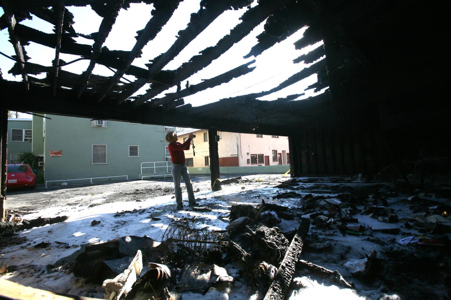 Heidi Schroeder takes photos of the damaged carport at a Sweetzer Avenue apartment complex in West Hollywood.