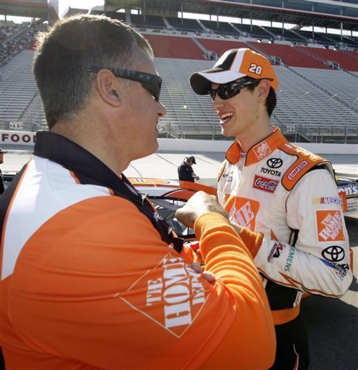 Joey Logano, right, is congratulated by a crew member after qualifying for the NASCAR Sprint Cup series Food City 500 auto race at Bristol Motor Speedway in Bristol, Tenn., Friday, March 19, 2010. Logano won the pole position for the race with a speed of 124.630 mph. (AP Photo/Chuck Burton)