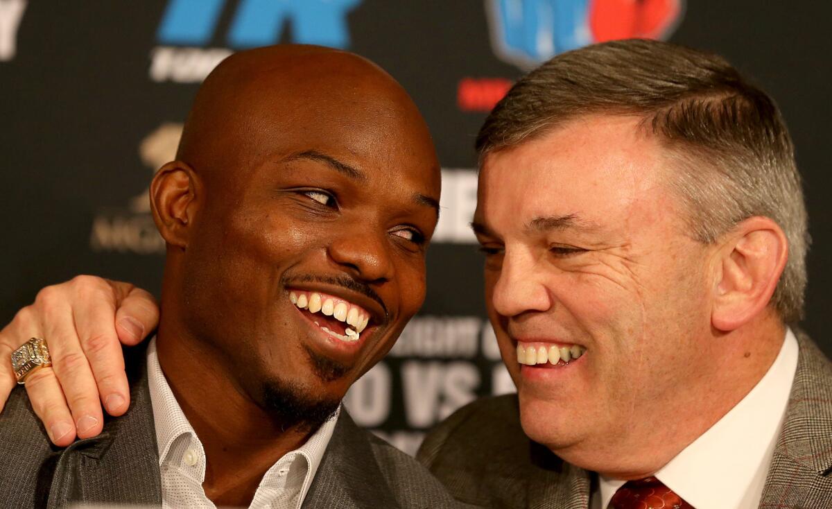 Timothy Bradley talks on Jan. 19 with trainer Teddy Atlas, right, during a news conference to promote his third fight against Manny Pacquiao.