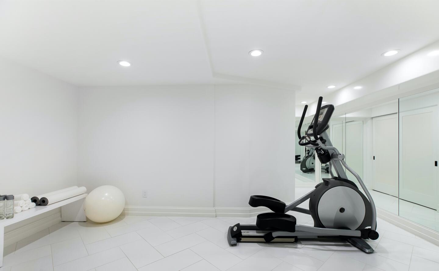 White walled gym and exercise equipment.