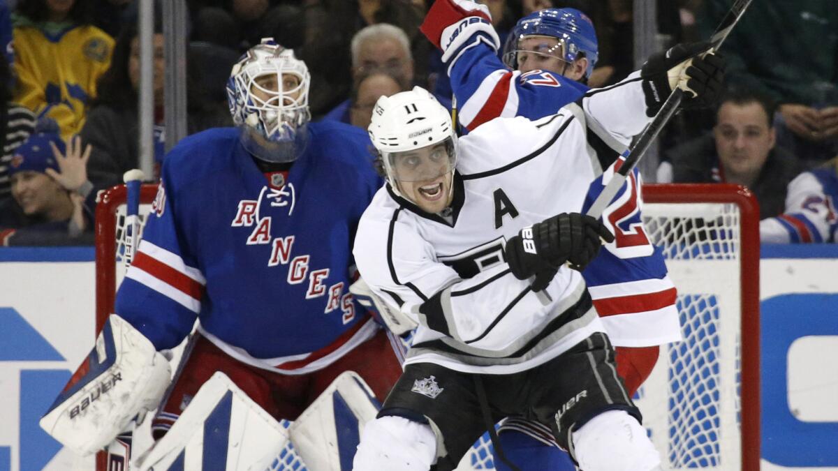 Kings center Anze Kopitar, right, battles for position in front of New York Rangers goalie Henrik Lundqvist during the second period of the Kings' 1-0 win on Nov. 17.