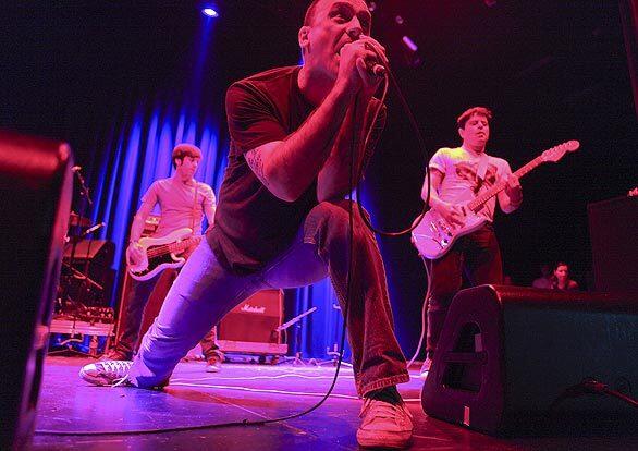 Screeching Weasel's frontman, Ben Weasel, with guitarist Drew Fredrichsen, right, and Justin Perkins on bass, left, perform Sunday at Club Nokia in downtown Los Angeles.
