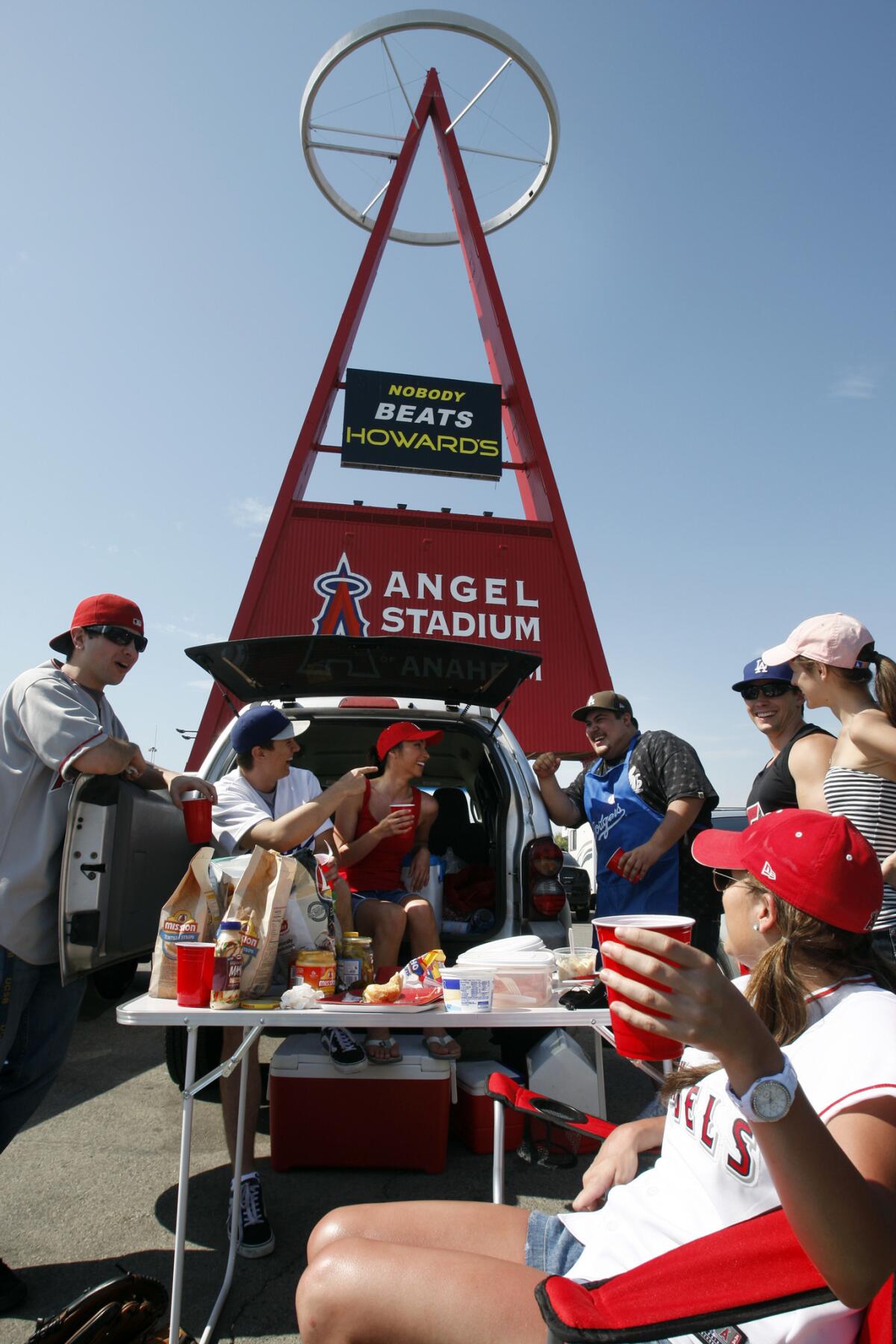 Angels and Dodgers fans — all alumni of UC Santa Barbara — gather for a tailgate party at Angels Stadium.