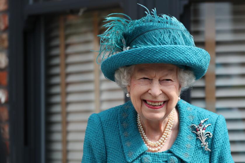 FILE - In this Thursday July 8, 2021 file photo, Britain's Queen Elizabeth visits the set of the long running television series Coronation Street, in Manchester, England. Queen Elizabeth II and the Royal Family back the Black Lives Matter movement, one of her senior representatives has said in a television interview to be broadcast later Friday, Sept. 10. (AP Photo/Scott Heppell, file)