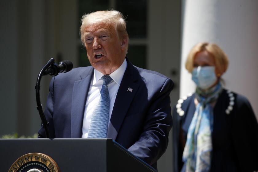 President Donald Trump speaks about the coronavirus in the Rose Garden of the White House, Friday, May 15, 2020, in Washington. Dr. Deborah Birx, White House coronavirus response coordinator, listens at right. (AP Photo/Alex Brandon)