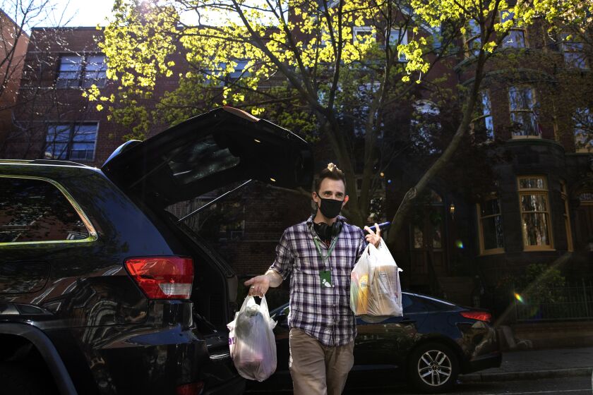 Matt Gillette, a 36 year-old Instacart shopper, makes a grocery delivery in Washington, DC, April 6, 2020.
