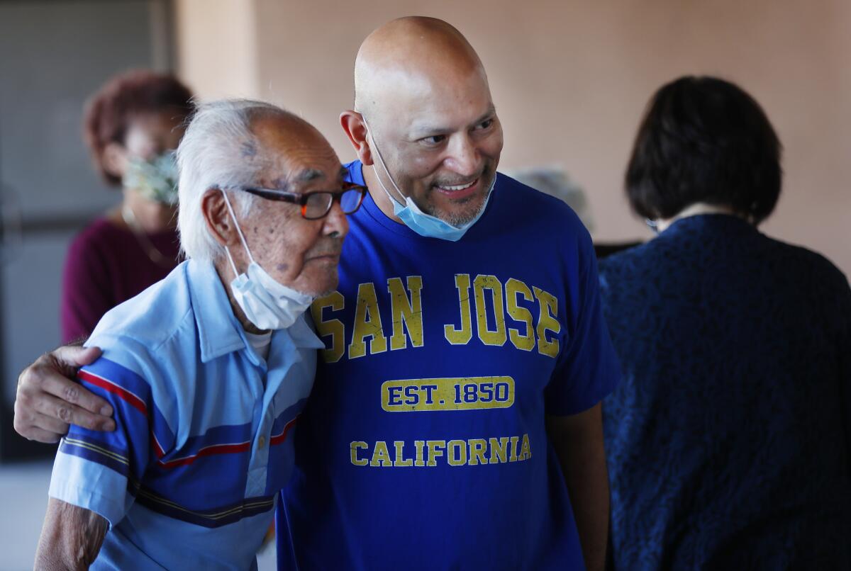 Judge Johnny Gogo, right, takes a photo with Hank Wada, 94.