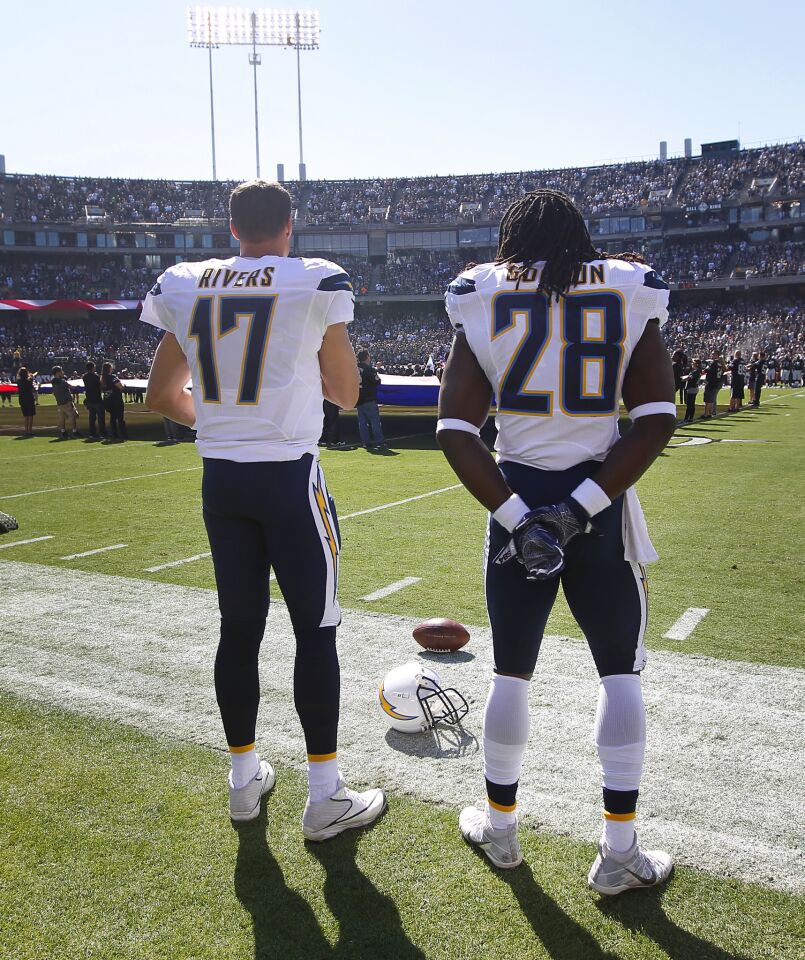 San Diego Chargers Philip Rivers and Melvin Gordon listen to the national anthem before a game against the Raiders in Oakland on Oct. 9, 2016. (Photo by K.C. Alfred/The San Diego Union-Tribune)