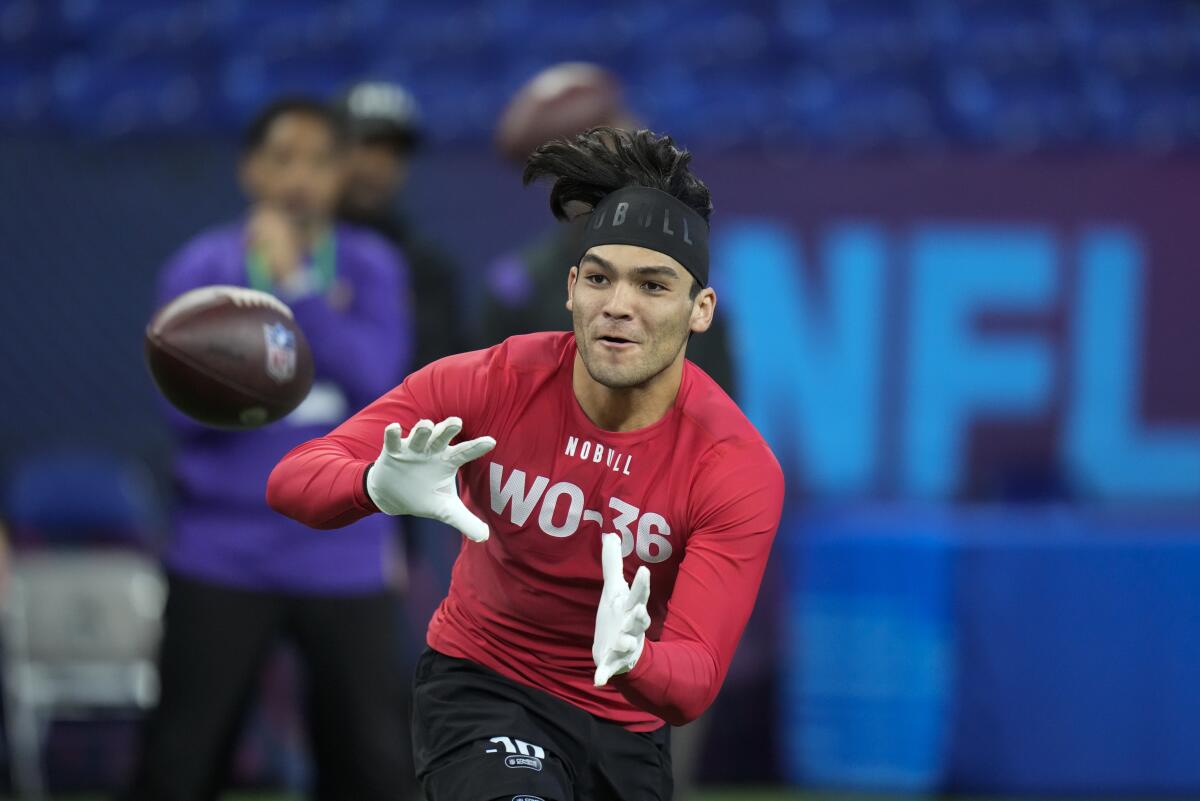  Puka Nacua's hair flails in the air during the NFL combine.