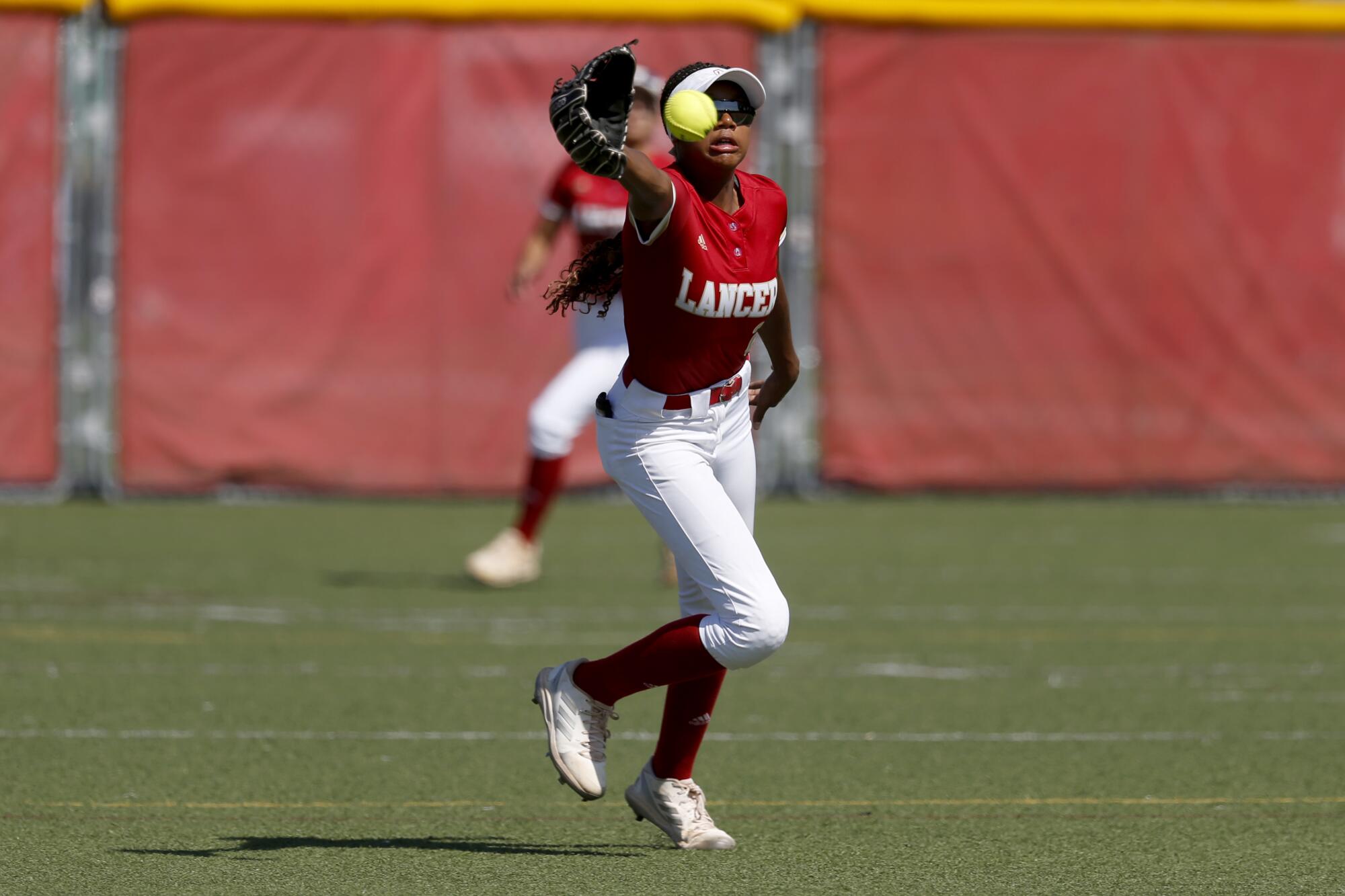 Orange Lutheran center fielder Kai Minor tracks down a ball during a game against Santa Margarita.