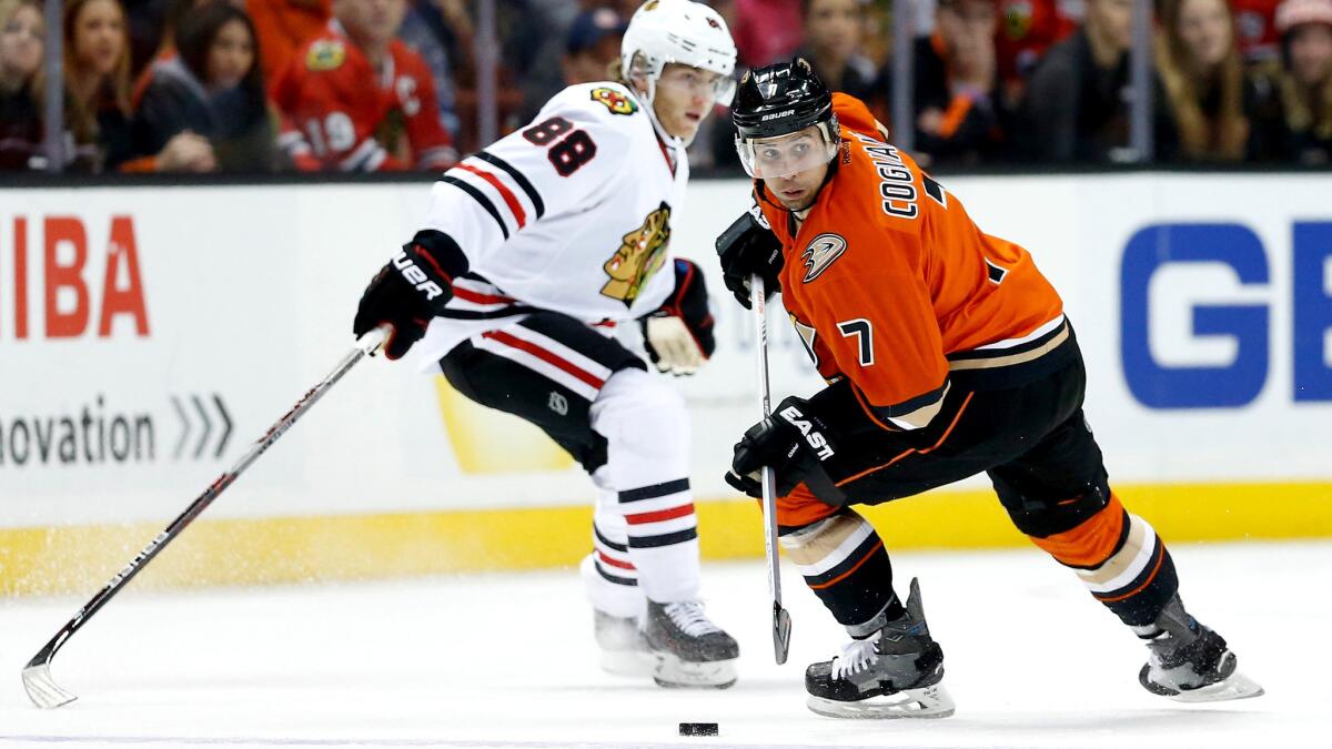 Ducks left wing Andrew Cogliano brings the puck up ice against Blackhawks center Patrick Kane during a game Nov. 27, 2015.